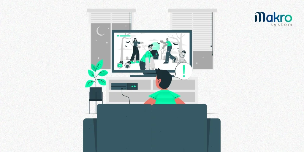 Um homem com roupas verdes, com um balão na cabeça que exibe um ponto de exclamação, jogando um jogo de zumbis em um console, ao lado de uma planta.